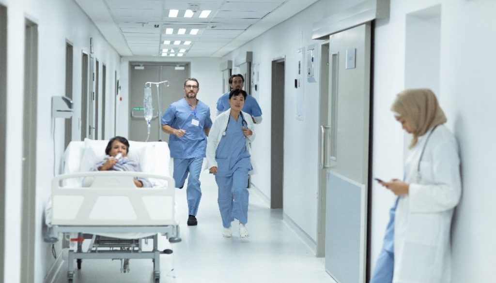 nurses running down hospital corridor